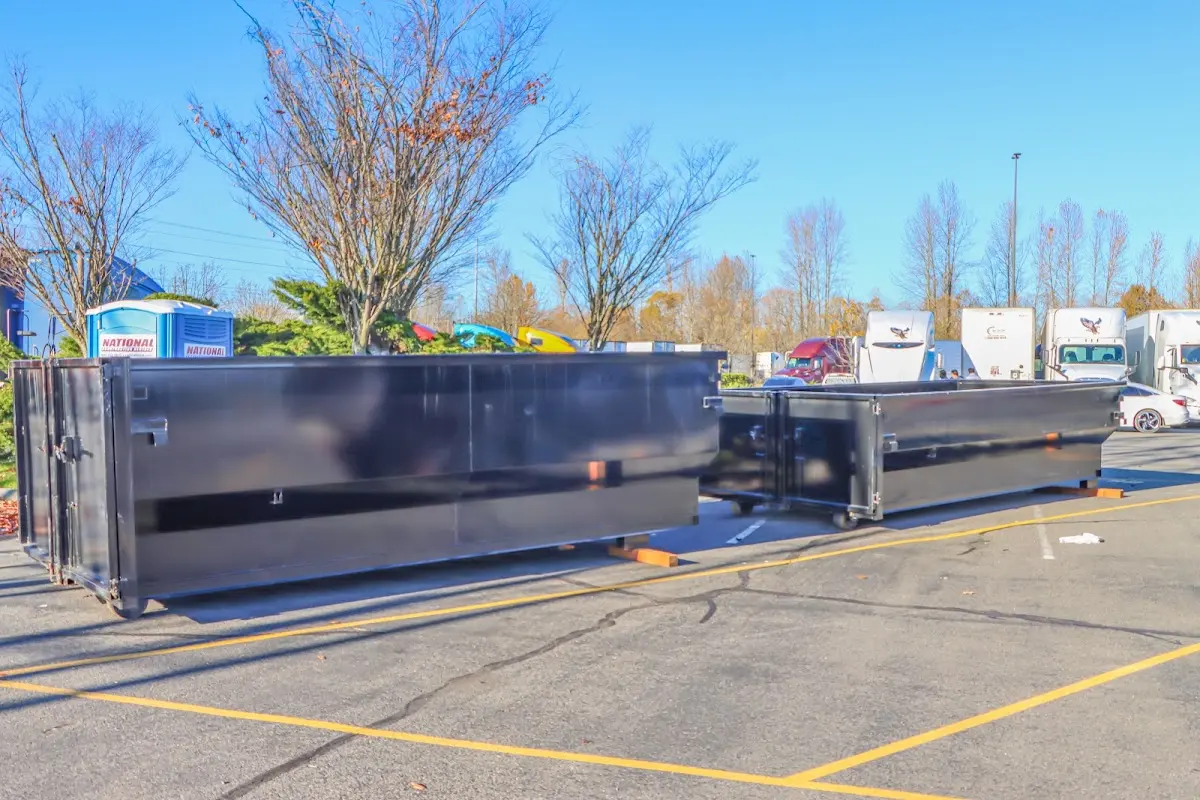 Professional dumpster rental service with roll-off container on residential driveway in Happy Valley